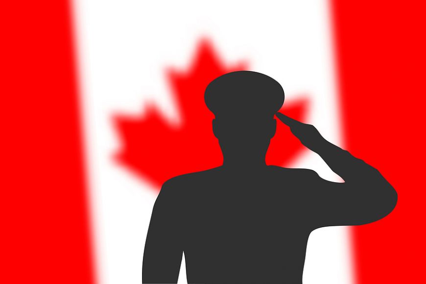 Solder Silhouette On Blur Background With Canada Flag.